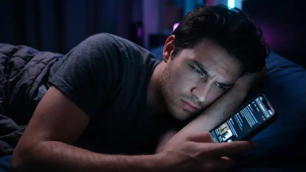 frustrated man typing on phone and he try to find movie name